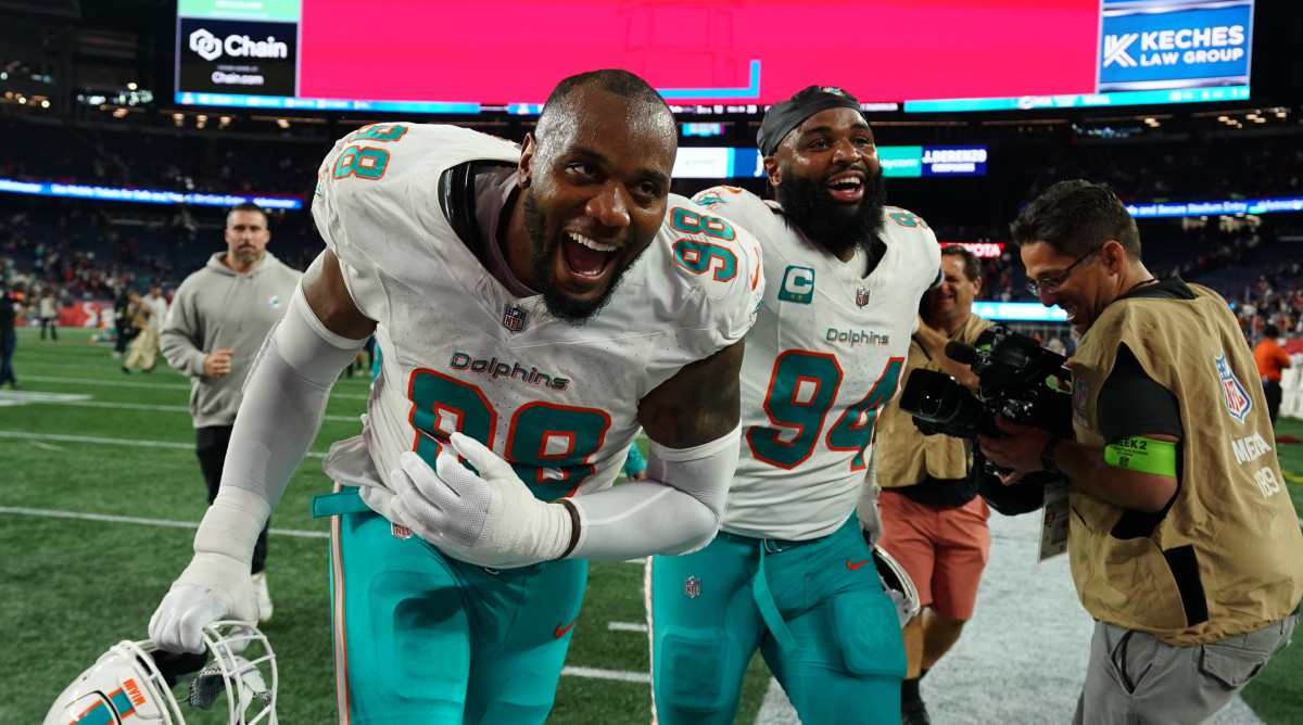 Dolphins defensive tackle Raekwon Davis, left, and defensive tackle Christian Wilkins react after defeating the Patriots at Gillette Stadium in Week 2.