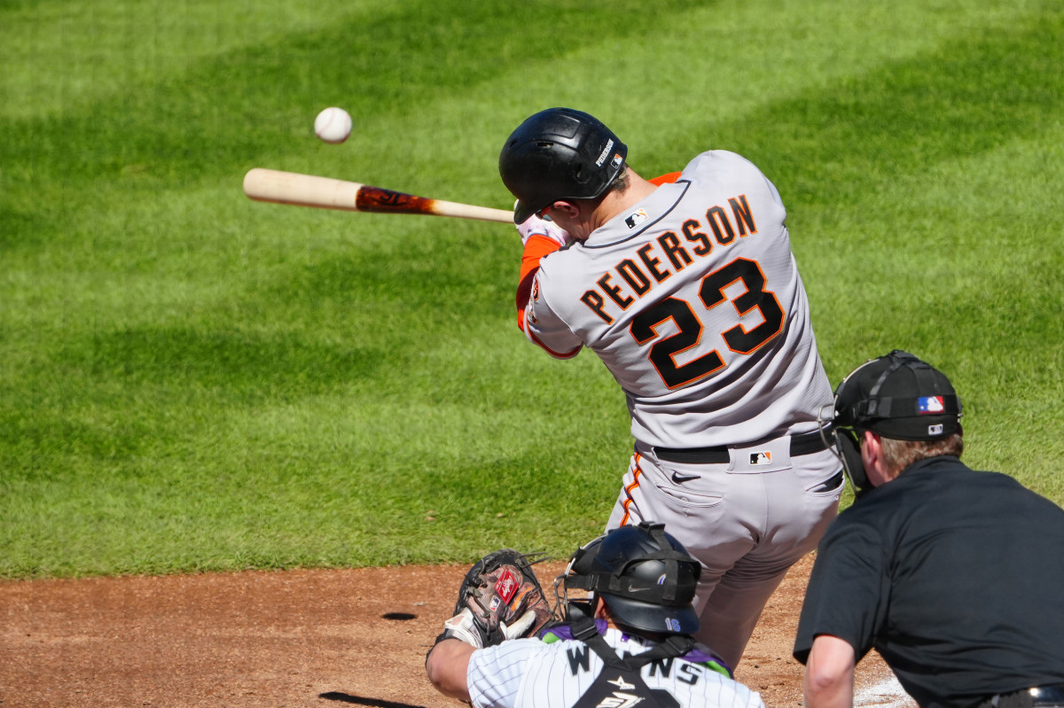 SF Giants designated hitter Joc Pederson hits an RBI double in the sixth inning against the Colorado Rockies at Coors Field on September 17, 2023.