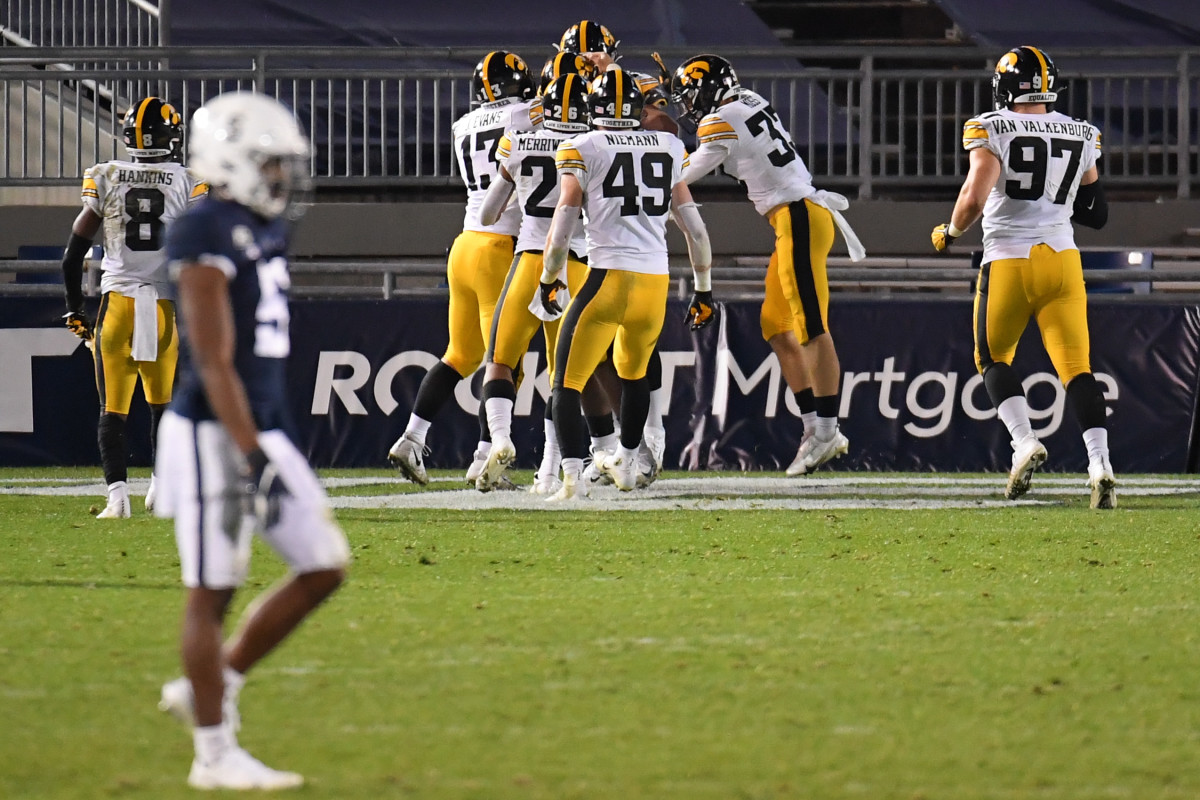 Iowa defensive players celebrate a defensive touchdown during their 2020 victory over Penn State at Beaver Stadium.
