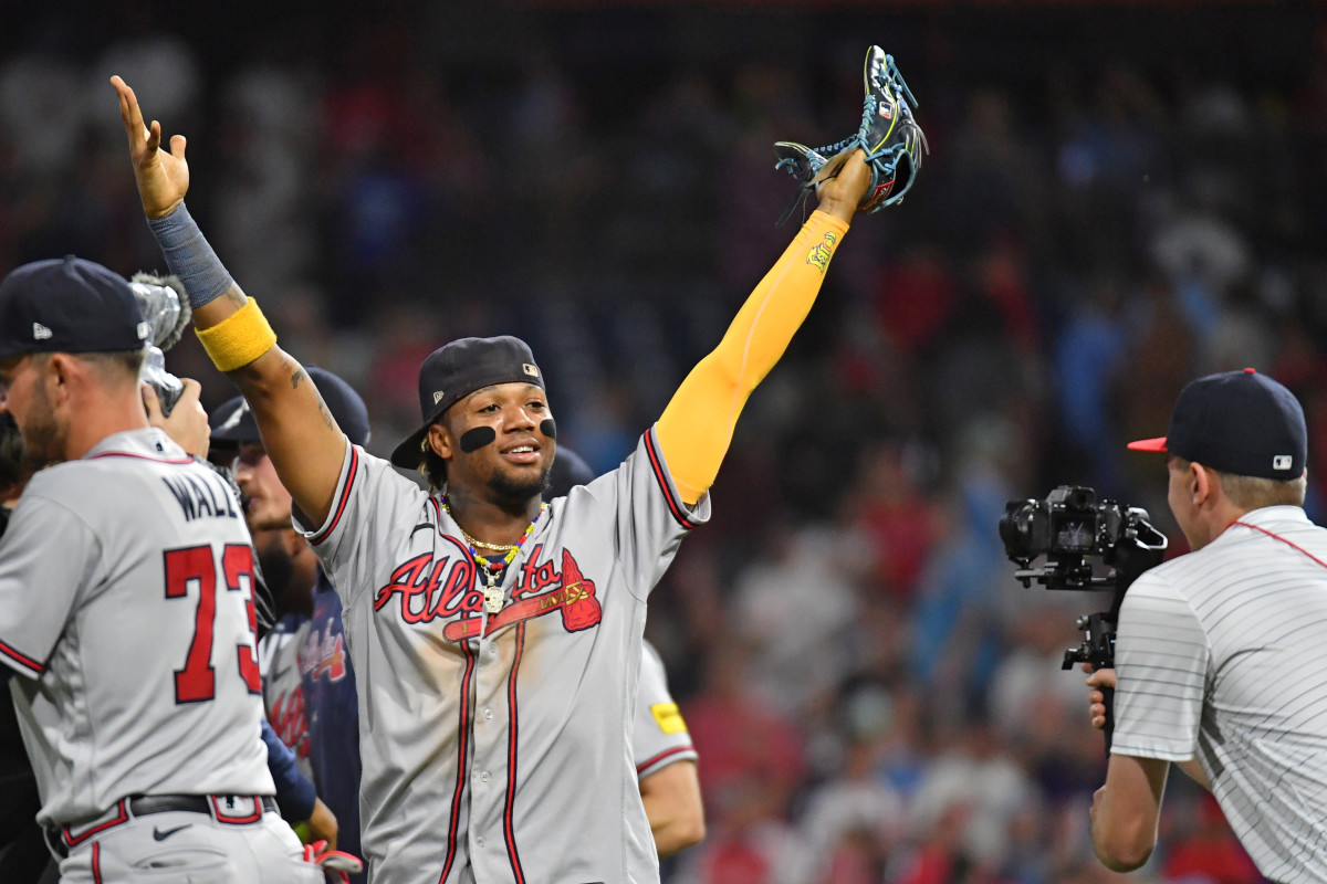 Ronald Acuna Jr puts his hands up in the air in celebration