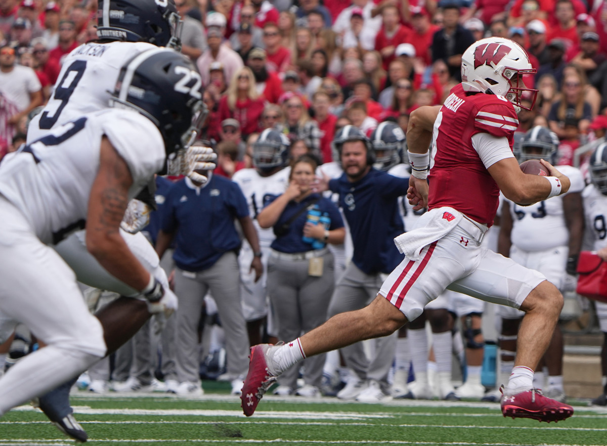 Sep 16, 2023; Madison, Wisconsin, USA; Wisconsin Badgers quarterback Tanner Mordecai (8) runs 18 yards for a touchdown against the Georgia Southern Eagles during the third quarter at Camp Randall Stadium. Mandatory Credit: Mark Hoffman-USA TODAY Sports
