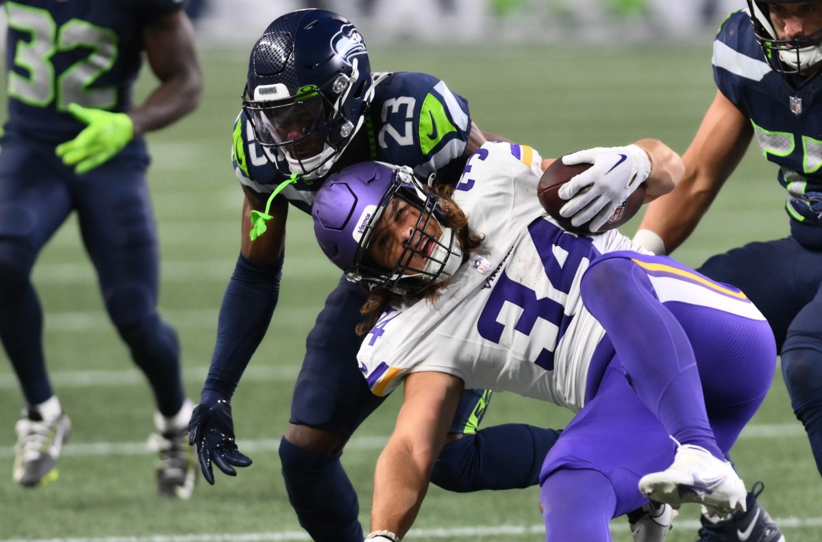 Minnesota Vikings tight end Nick Muse (34) is tackled by Seattle Seahawks cornerback Artie Burns (23) during the second half at Lumen Field.