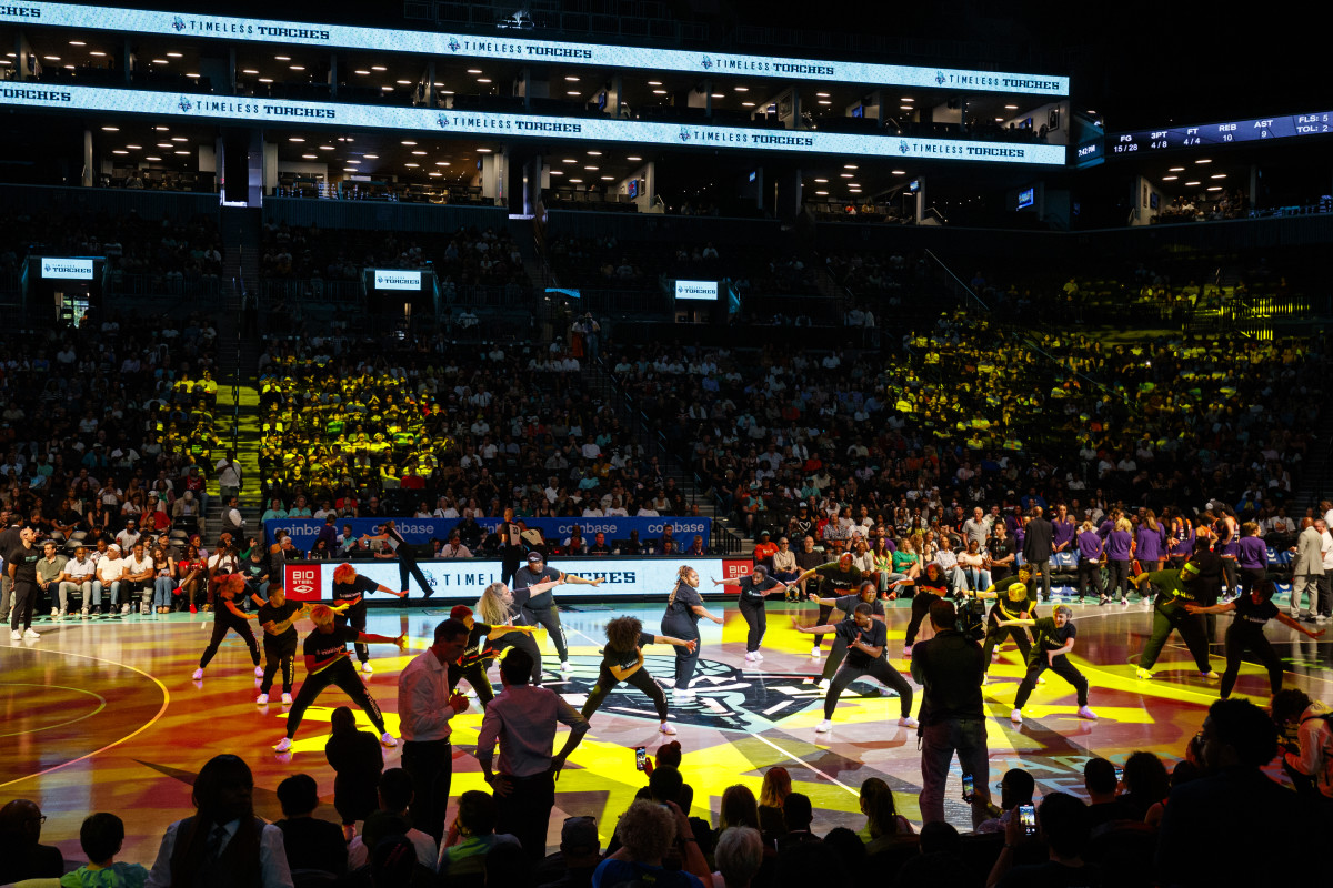 A shot from the crowd as the New York Liberty's dance squad the Timeless Torches perform on the court.