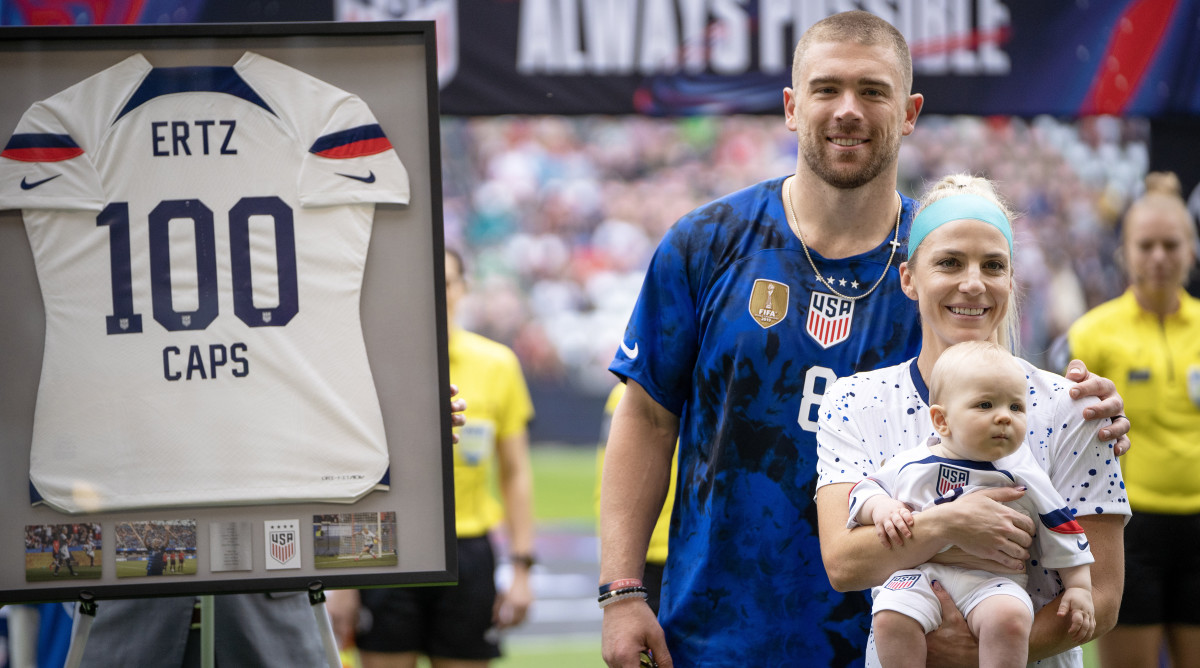 U.S. Women's National Team midfielder Julie Ertz poses with her husband and son as she is celebrated for becoming the 40th U.S. female to hit 100 caps.