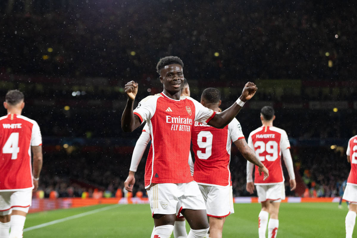Bukayo Saka pictured (center) after scoring for Arsenal on his UEFA Champions League debut against PSV Eindhoven in September 2023