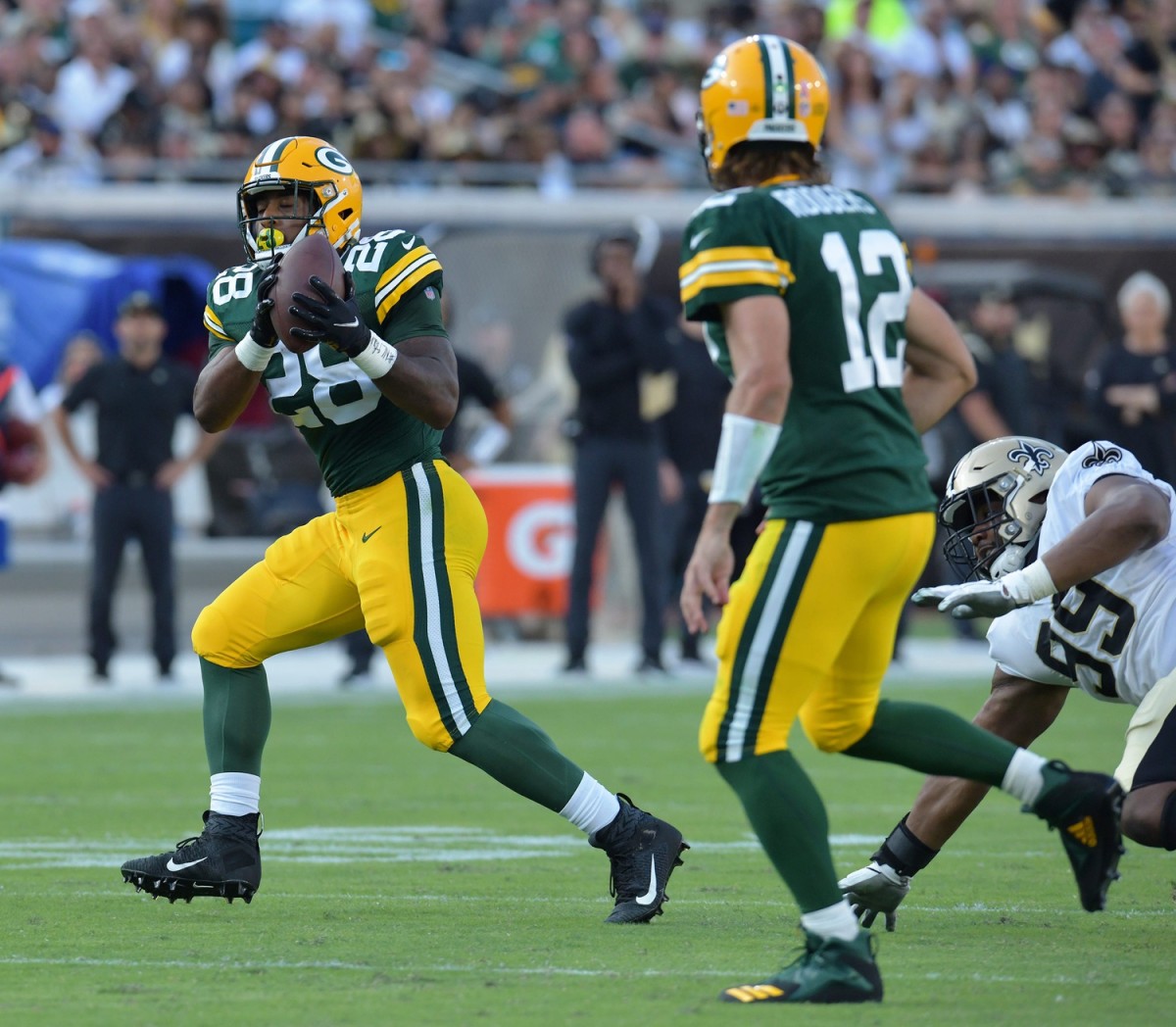 September 12, 2021; Green Bay Packers running back A.J. Dillon (28) pulls in a short pass against the New Orleans Saints.  © Bob Self/Florida Times-Union via Imagn Content Services, LLC