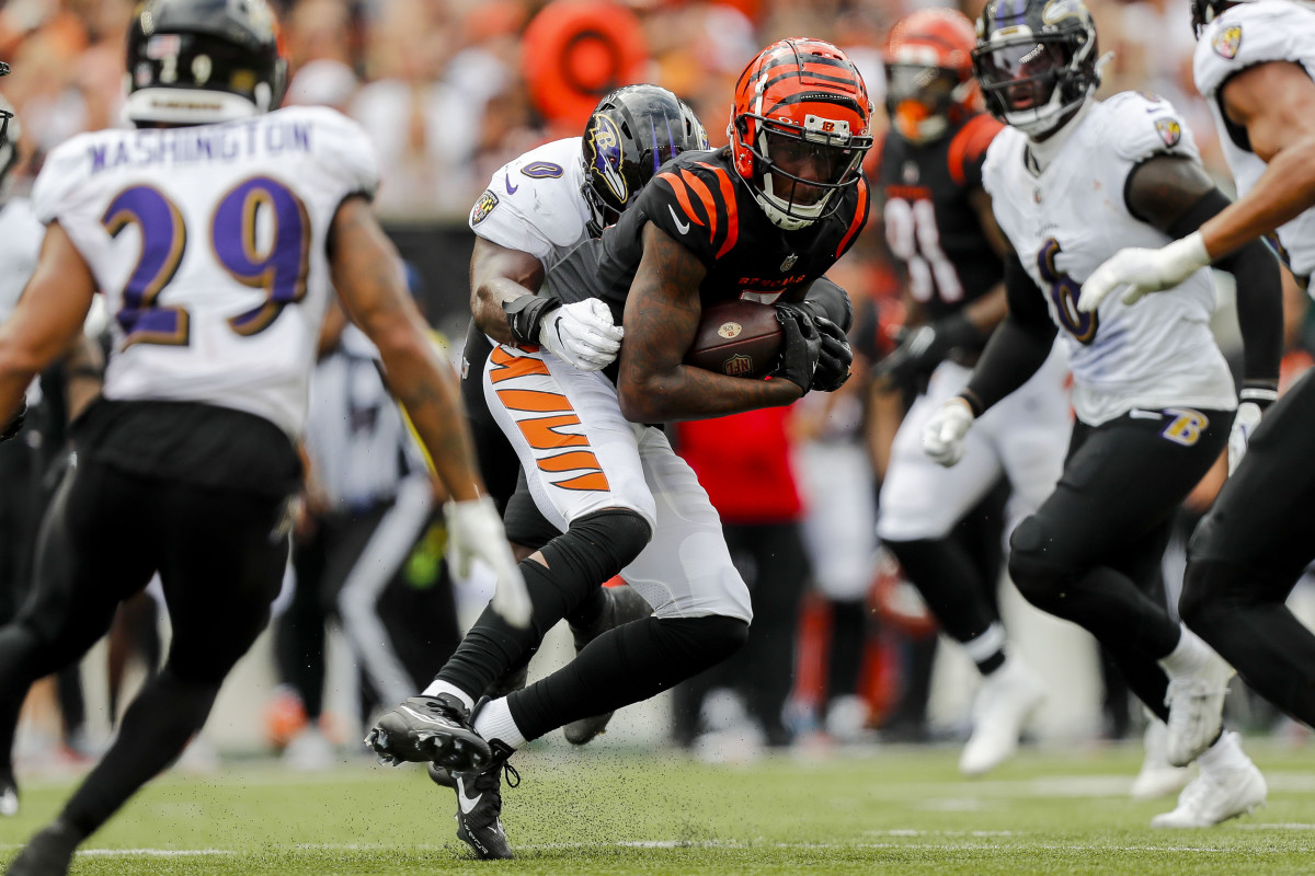 Sep 17, 2023; Cincinnati, Ohio, USA; Cincinnati Bengals wide receiver Tee Higgins (5) runs with the ball against Baltimore Ravens linebacker Roquan Smith (0) in the second half at Paycor Stadium. Mandatory Credit: Katie Stratman-USA TODAY Sports