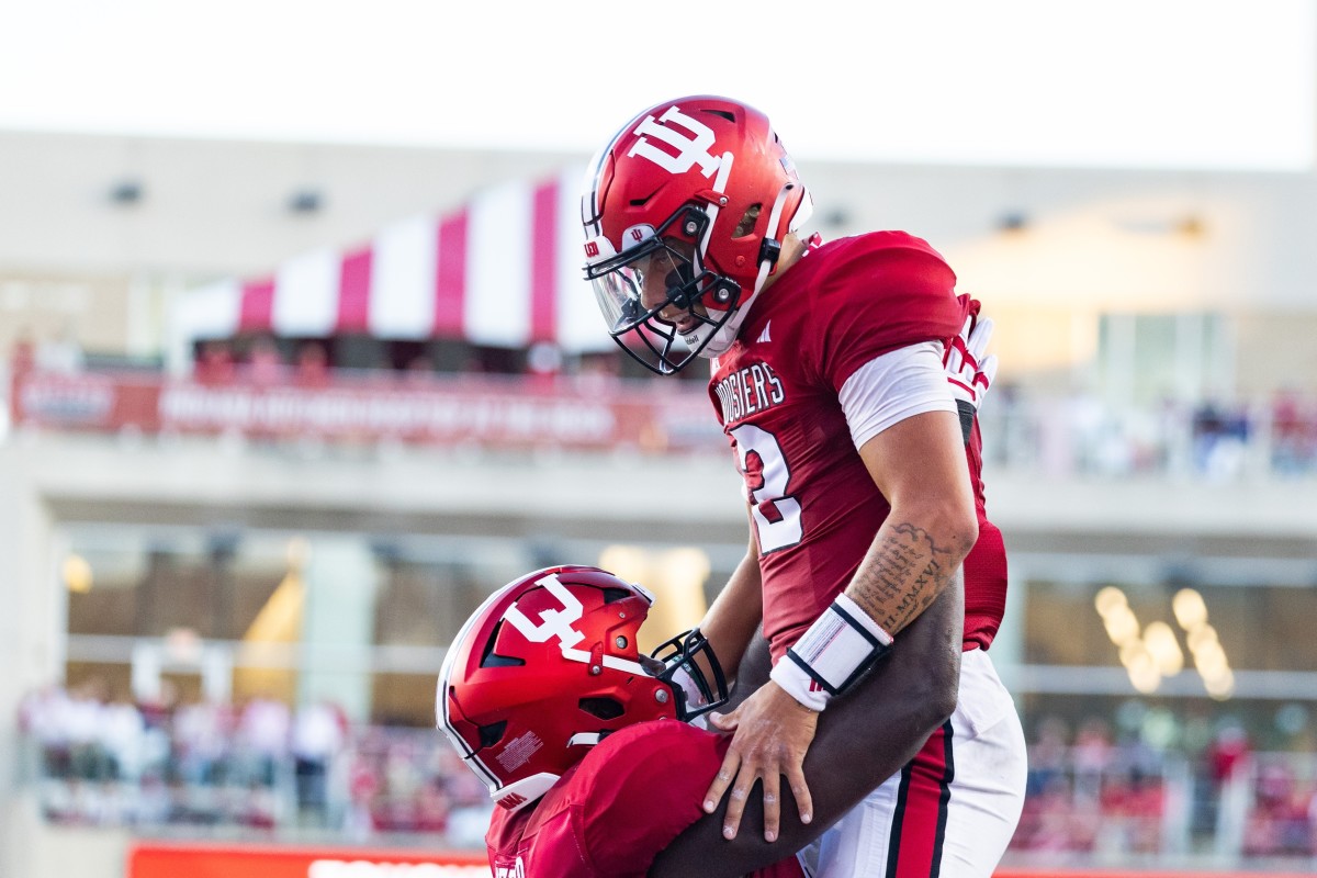Indiana offensive lineman Matthew Bedford lifts up quarterback Tayven Jackson (2) after his touchdown against the Indiana State Sycamores at Memorial Stadium.