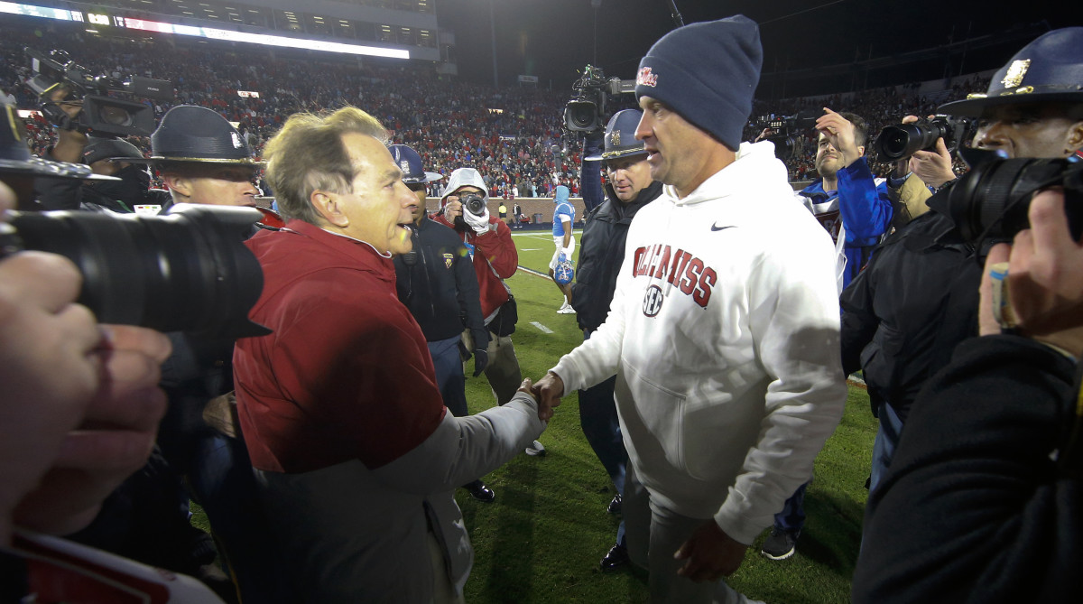 Alabama Crimson Tide Head Coach Nick Saban (left) and Mississippi Rebels head coach Lane Kiffin (right) shake hands.