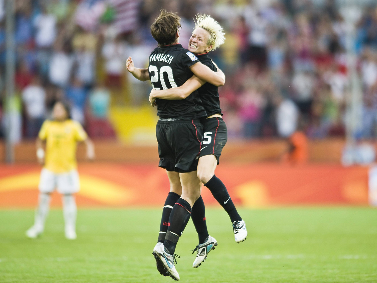 USWNT players Megan Rapinoe jumps up to hug teammate Abby Wambach after scoring against Brazil in the 2011 Women's World Cup.