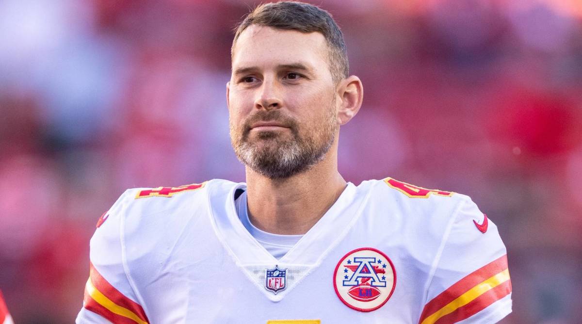 Chiefs quarterback Chad Henne looks on without a helmet before a game.