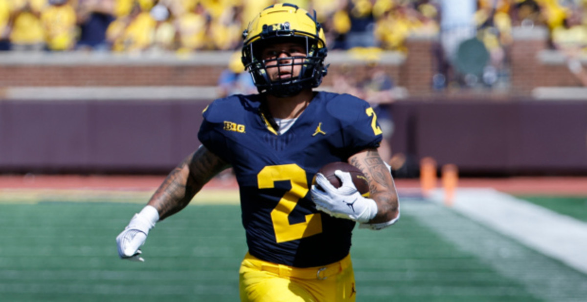 Michigan Wolverines running back Blake Corum on a rushing attempt during a college football game in the Big Ten.