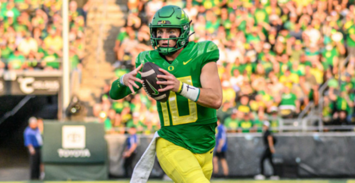 Oregon Ducks quarterback Bo Nix attempts a pass during a college football game.