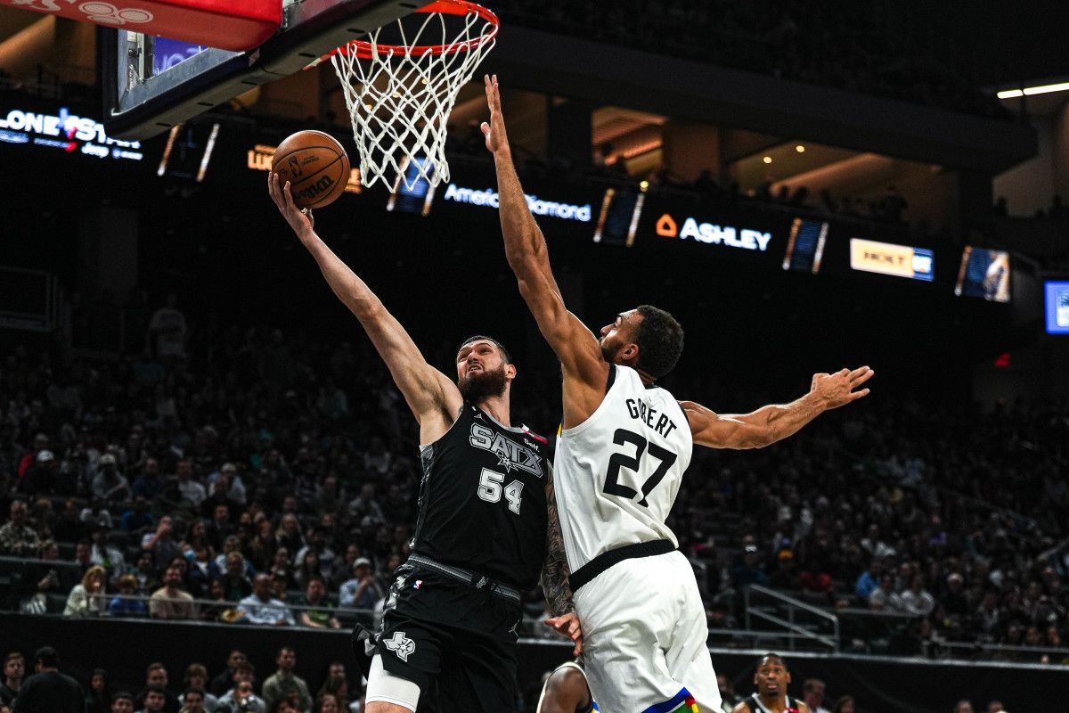 San Antonio Spurs forward Sandro Mamukelashvili (54) shoots past Minnesota Timberwolves center Rudy Gobert (27) during the game at the Moody Center on Saturday, April 8, 2023 in Austin.