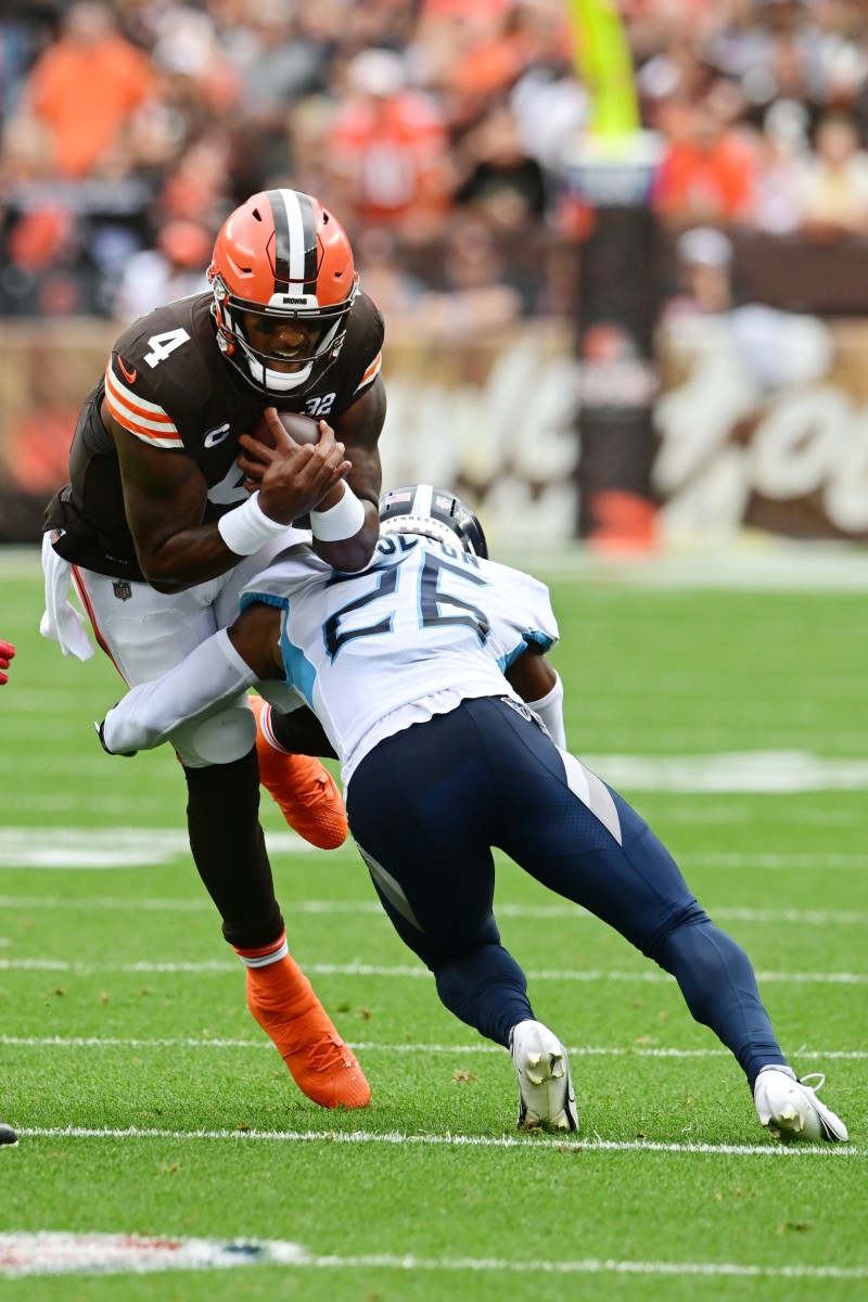 Tennessee Titans cornerback Kristian Fulton (26) tackles Cleveland Browns quarterback Deshaun Watson (4) during the first half at Cleveland Browns Stadium.
