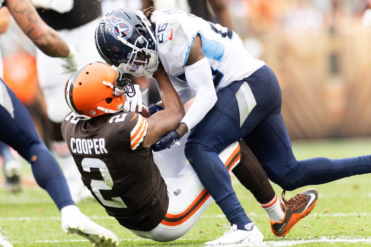 Titans cornerback Kristian Fulton (26) tackles Cleveland Browns wide receiver Amari Cooper (2) during the third quarter at Cleveland Browns Stadium. 