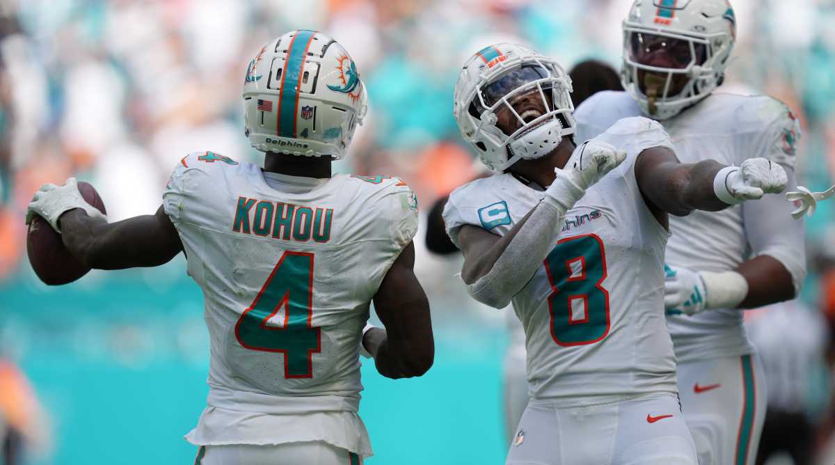 Dolphins safety Jevon Holland celebrates creating a turnover against the Broncos