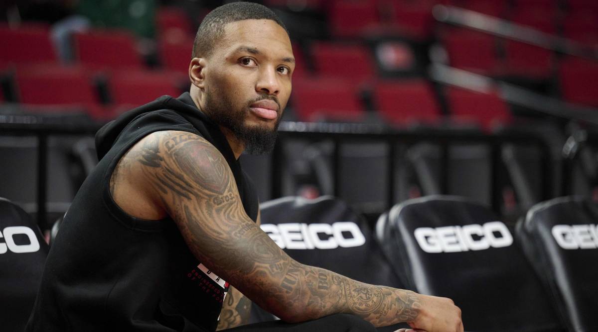 Trail Blazers point guard Damian Lillard looks on from the bench before a game.