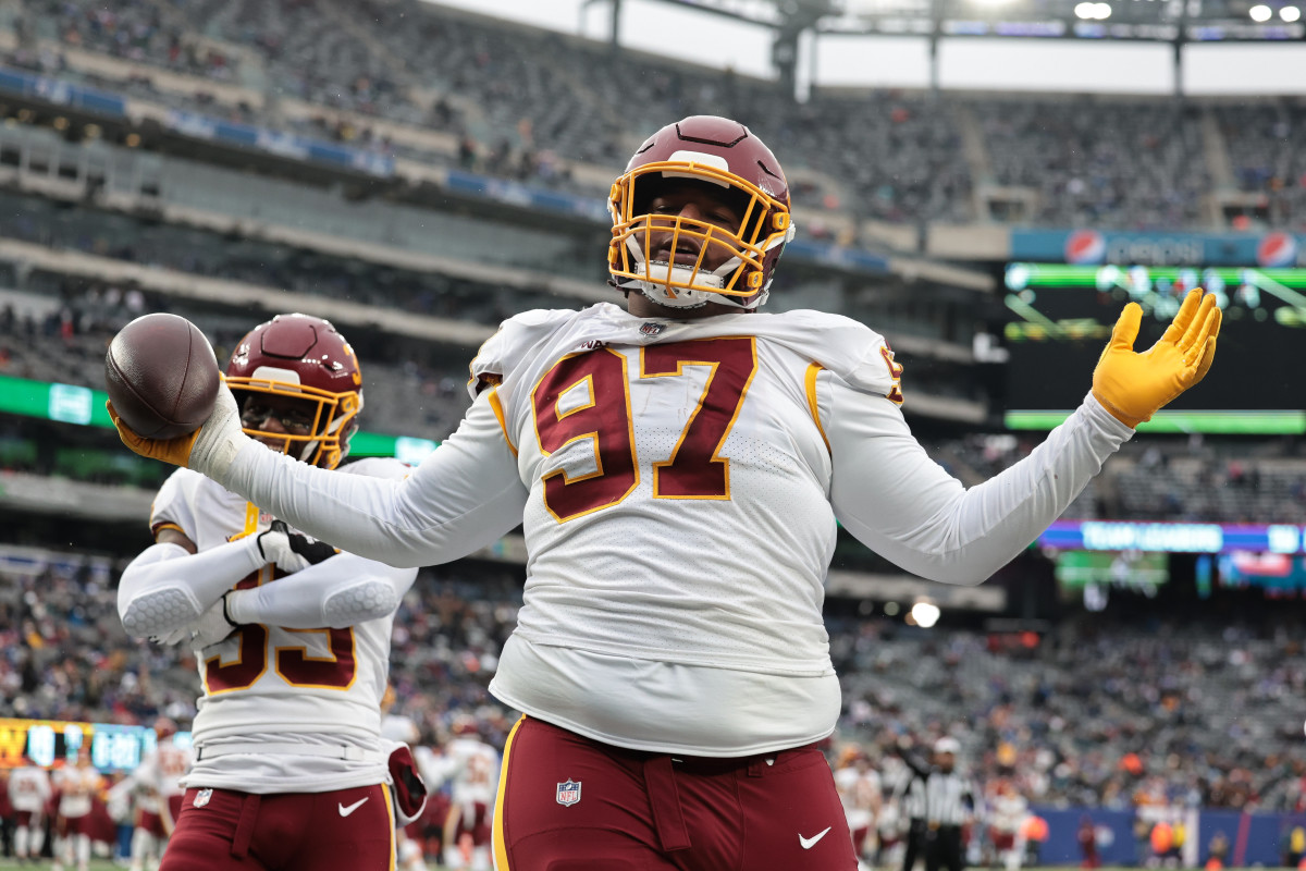 Washington Football Team defensive tackle Tim Settle (97) celebrates after recovering a fumble against the New York Giants during the second half at MetLife Stadium.