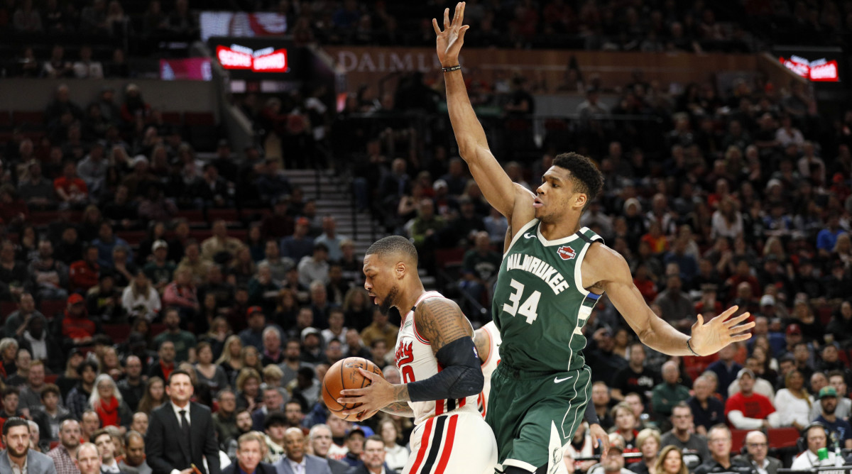 Giannis Antetokounmpo guarding Damian Lillard