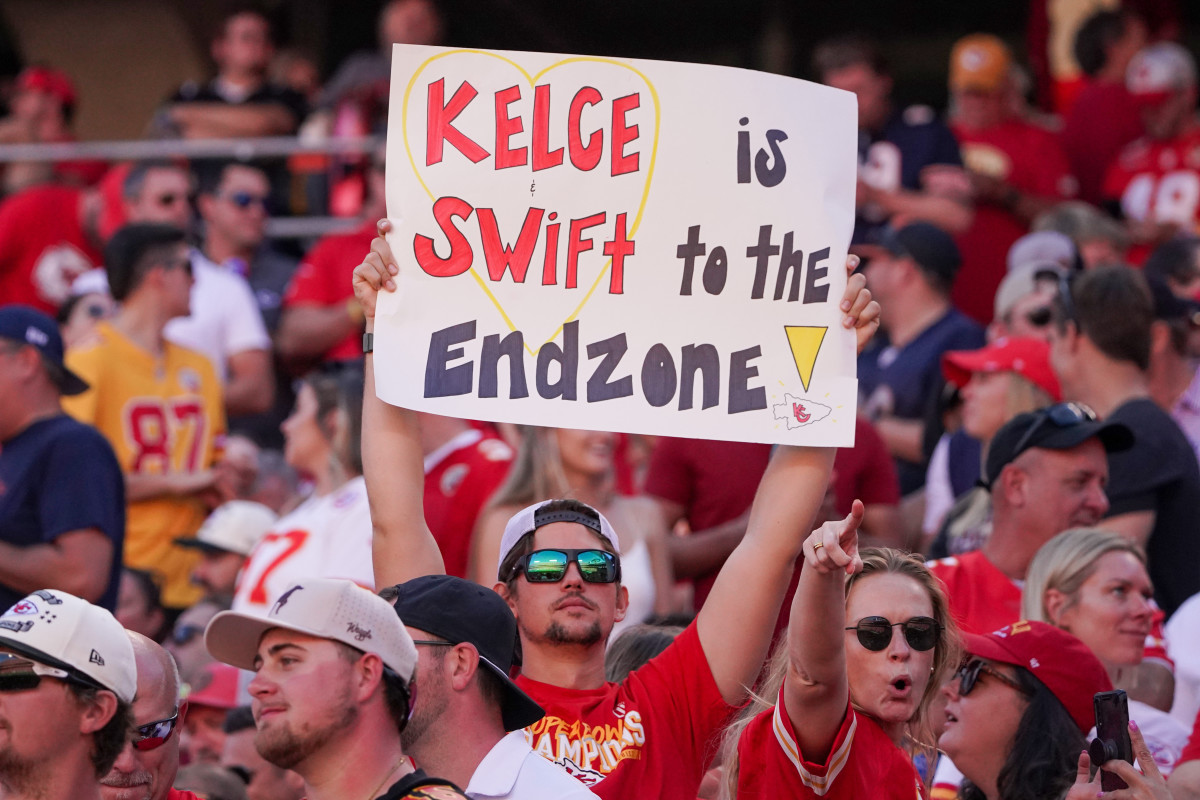 A fan holds up a sign with Kelce and Swift on it