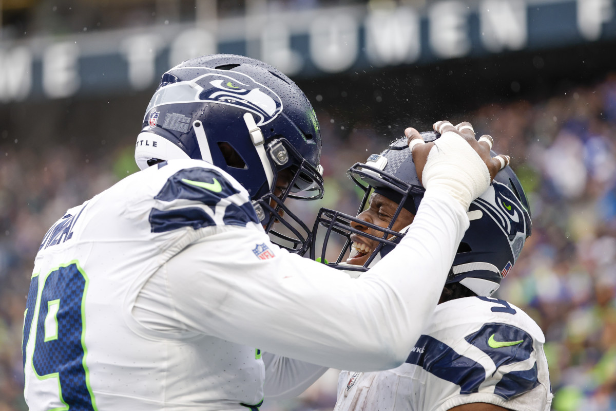 Seattle Seahawks running back Kenneth Walker III (9) celebrates with offensive tackle Raiqwon O'Neal (79) after rushing for a touchdown against the Carolina Panthers during the fourth quarter at Lumen Field.