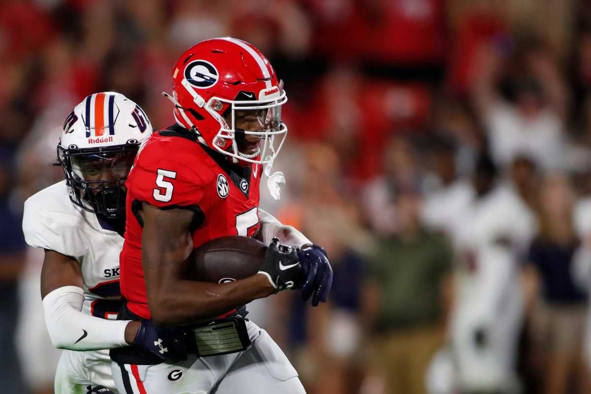 Georgia wide receiver Rara Thomas (5) tries to fight off a tackle from Tennessee Martin safety Antonio Jackson (23) after making a big catch during the second half of a NCAA college football game against Tennessee Martin in Athens, Ga., on Saturday, Sept. 2, 2023. Georgia won 48-7.