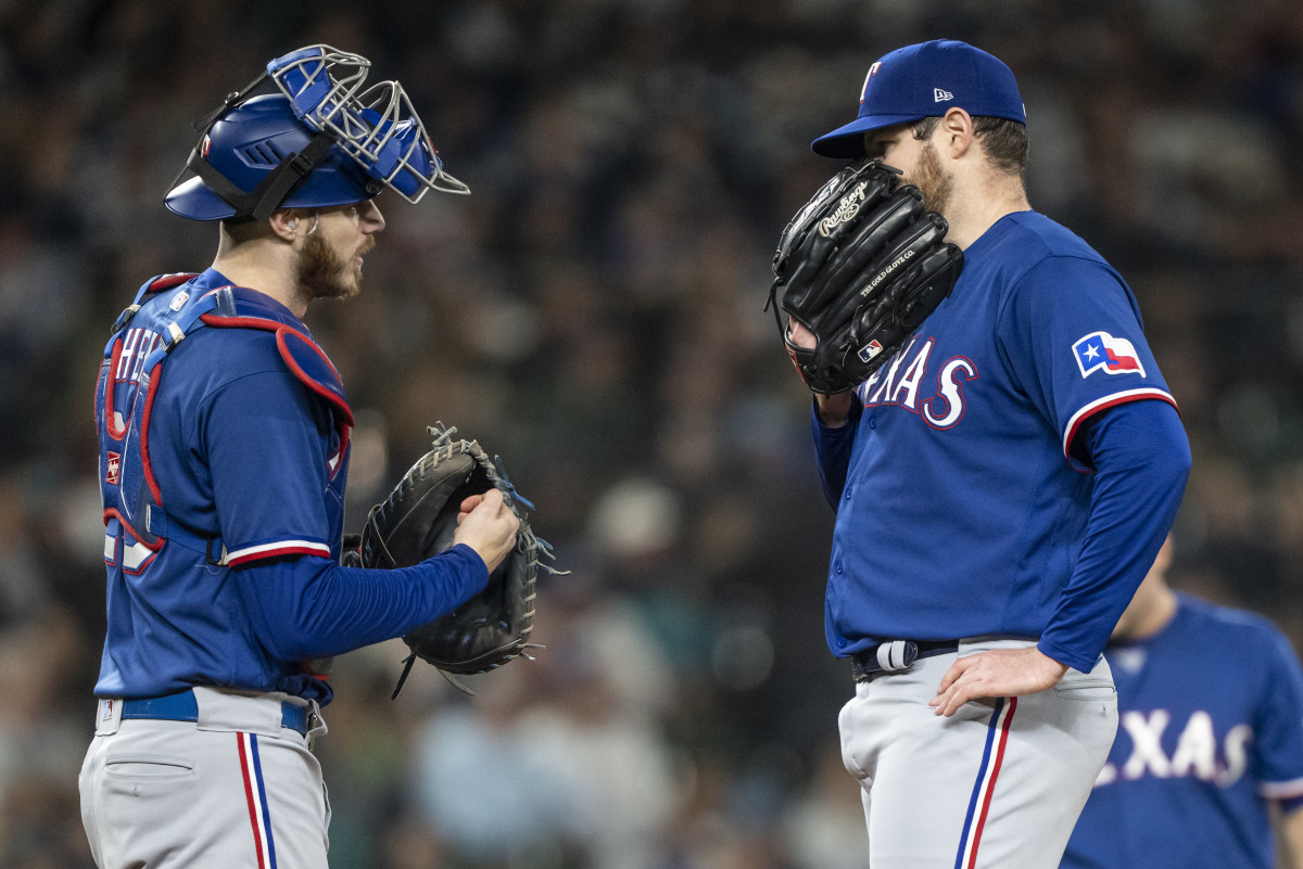Sep 28, 2023; Seattle, Washington, USA; Texas Rangers starting pitcher Jordan Montgomery (52) and catcher Jonah Heim (28) meet at the mound during the fourth inning against the Seattle Mariners at T-Mobile Park. Mandatory Credit: Stephen Brashear-USA TODAY Sports