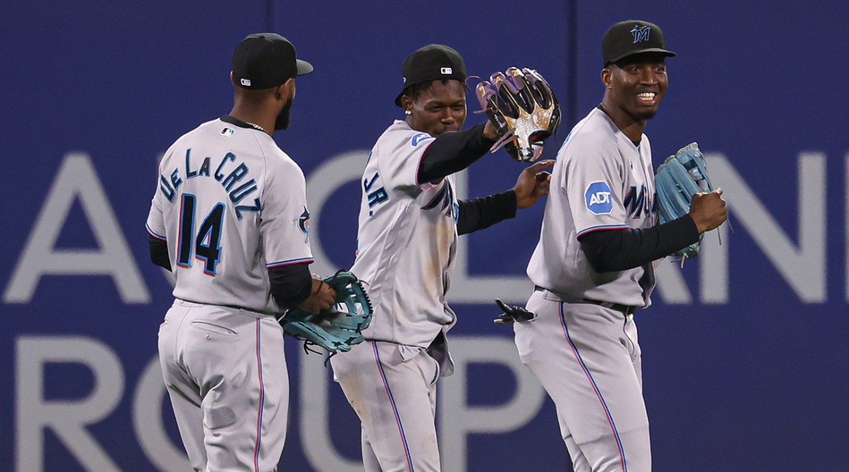 Marlins outfielders celebrate at Citi Field.