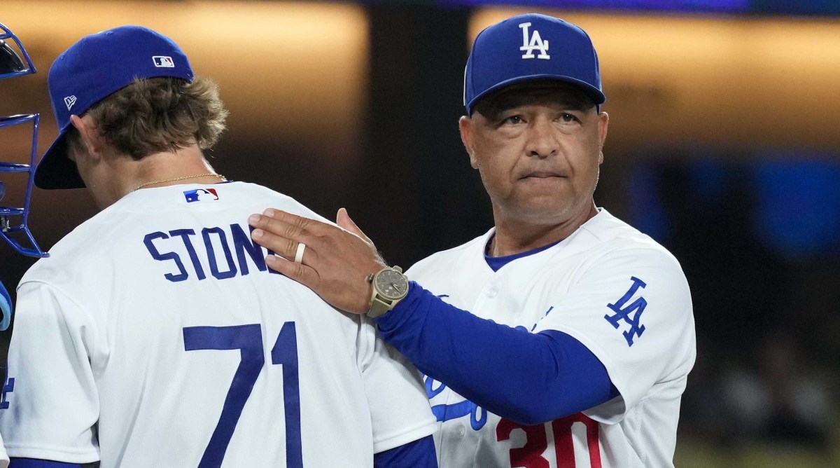 Dodgers manager Dave Roberts, right, removes pitcher Gavin Stone from a game