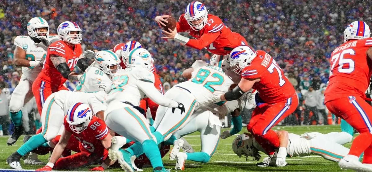 Josh Allen (17) fights for yardage in last year's matchup against Miami.
