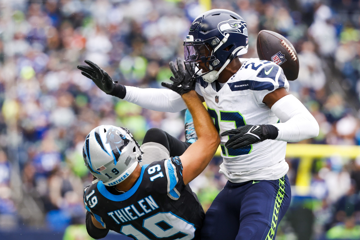 Seattle Seahawks cornerback Artie Burns (23) defends a pass intended for Carolina Panthers wide receiver Adam Thielen (19) during the second quarter at Lumen Field. 