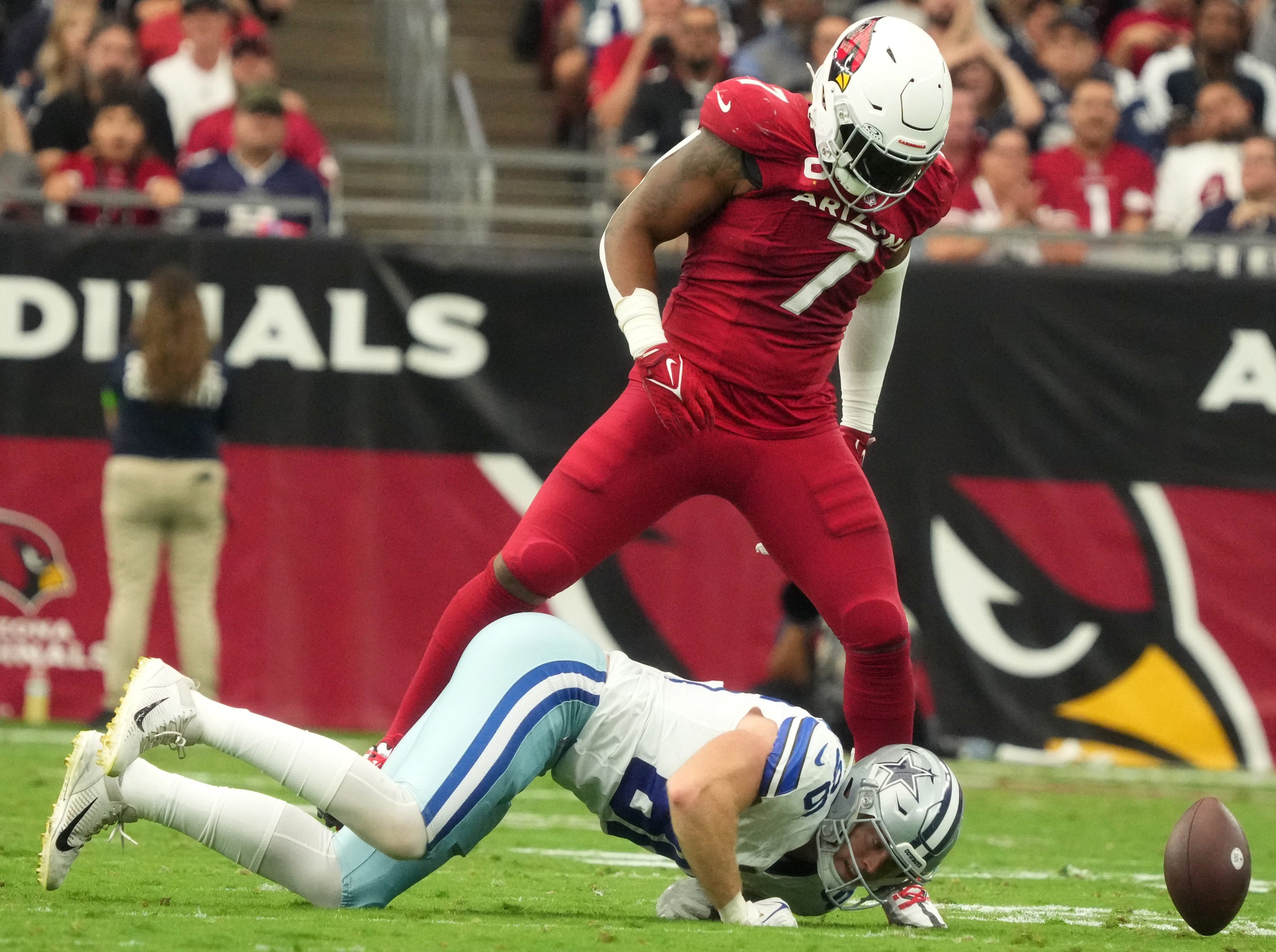 Arizona Cardinals linebacker Kyzir White (7) stands over Dallas Cowboys tight end Luke Schoonmaker (86) after breaking up a pass play at State Farm Stadium in Glendale on Set. 24, 2023.  