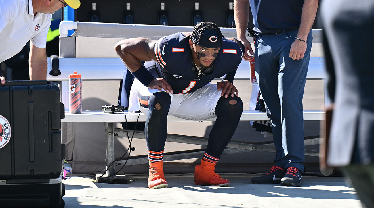 Justin Fields sits on the Bears bench during a loss to the Broncos