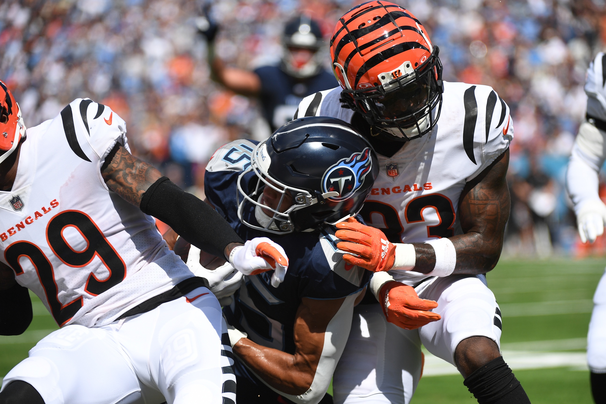 Tennessee Titans wide receiver Nick Westbrook-Ikhine (15) scores as he is hit by Cincinnati Bengals cornerback Cam Taylor-Britt (29) at the goal line at Nissan Stadium.