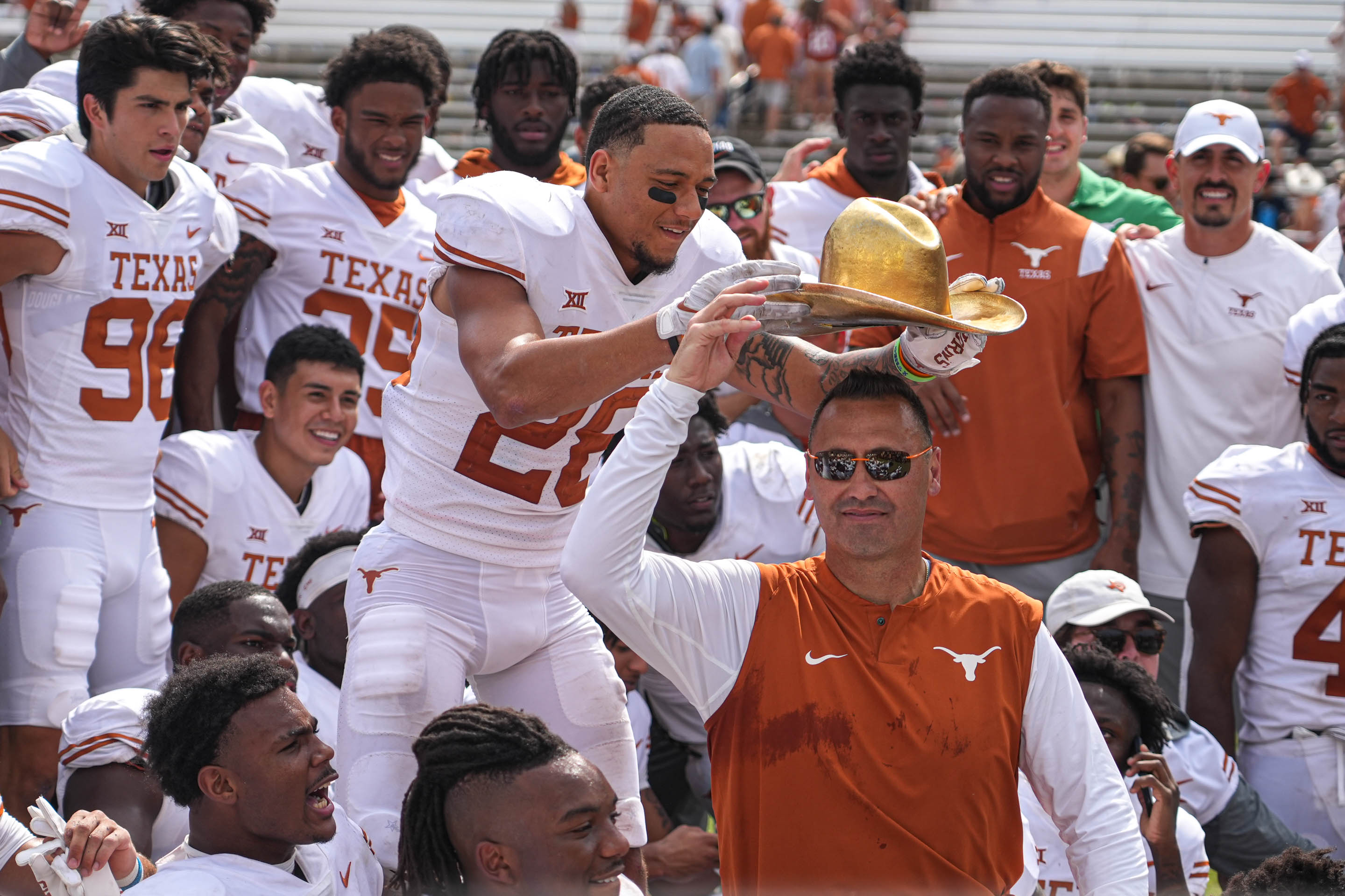 Dallas, Texas, USA: Texas Longhorns Longhorns defensive back Derrin Thompson (28) places the Golden Hat on the head of head coach Steve Sarkisian after a 49-0 victory over the Oklahoma Sooners