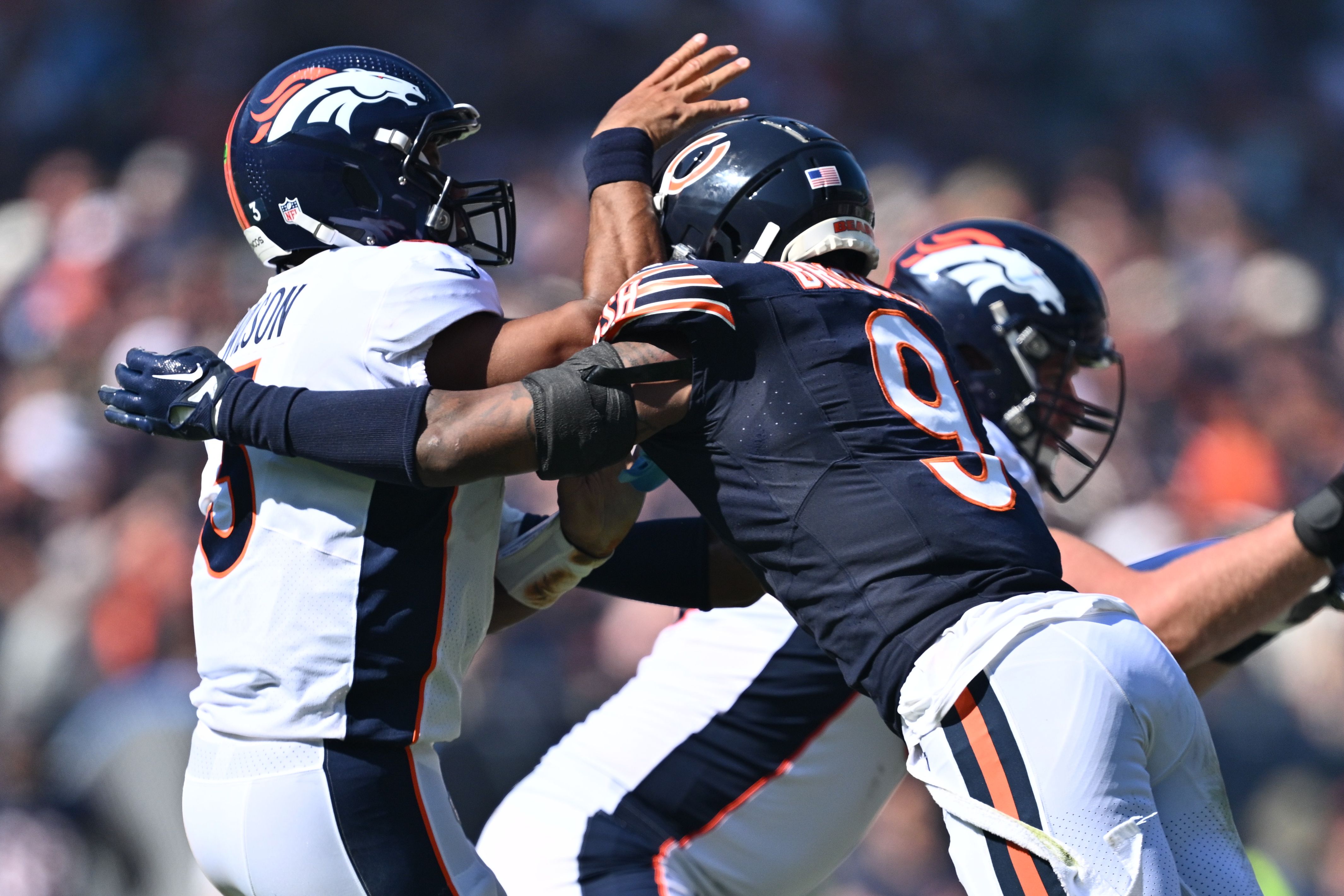 Chicago Bears safety Jaquan Brisker (9) chases Denver Broncos quarterback Russell Wilson (3) at Soldier Field Sunday.