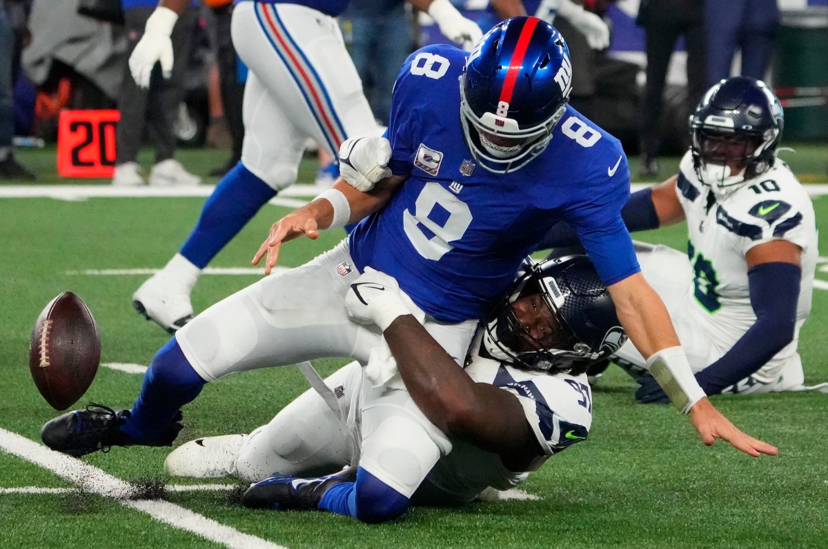 Seattle Seahawks defensive end Mario Edwards Jr. (97) strips the ball from New York Giants quarterback Daniel Jones (8) and the Seahawks recovered at MetLife Stadium.