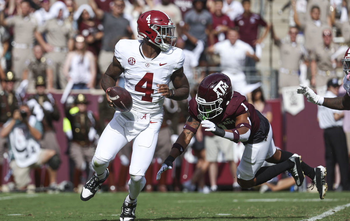 Oct 7, 2023; College Station, Texas, USA; Alabama Crimson Tide quarterback Jalen Milroe (4) scrambles with the ball as Texas A&M Aggies defensive back Bryce Anderson (1) applies defensive pressure during the second quarter at Kyle Field.