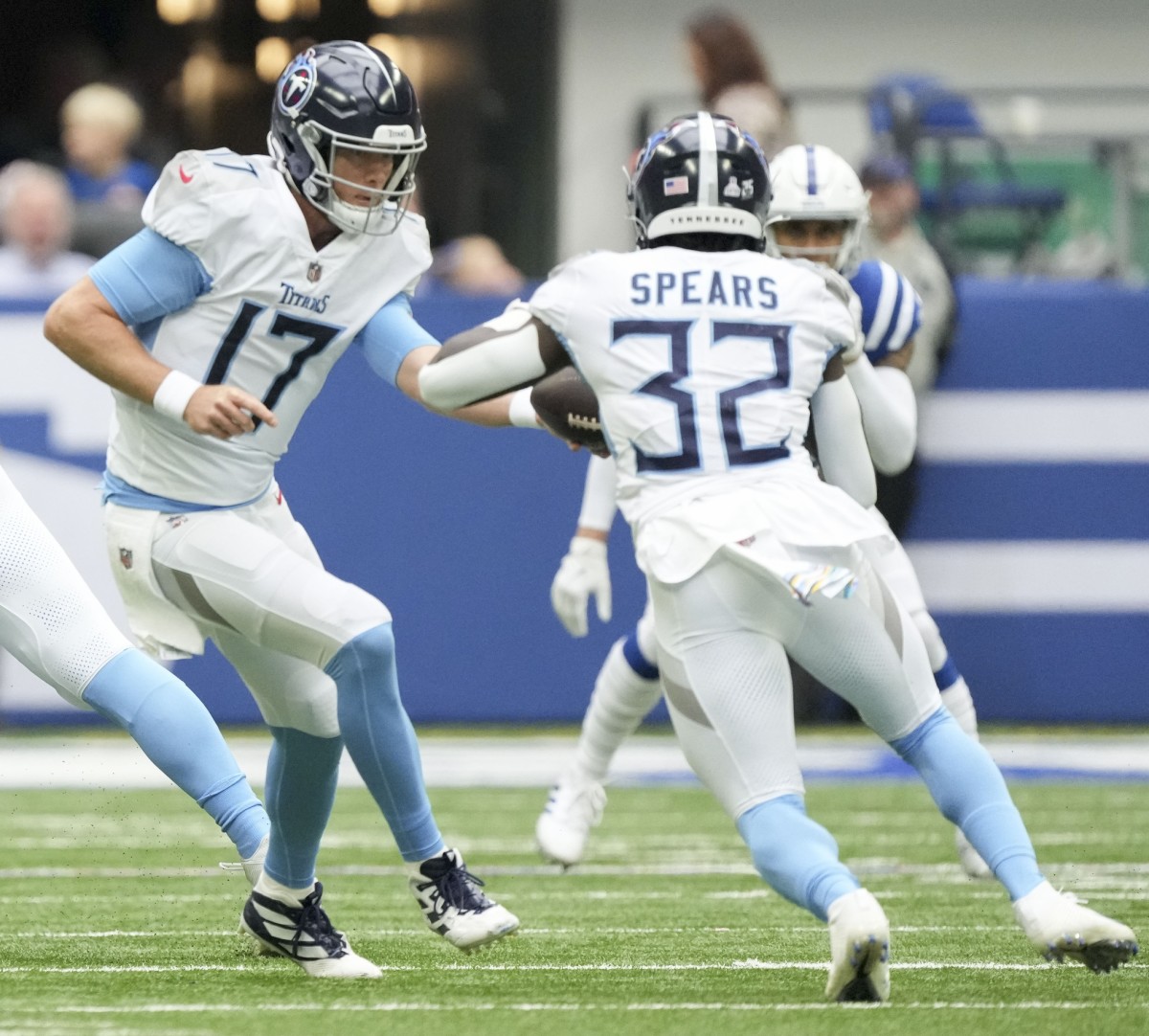 Tennessee Titans quarterback Ryan Tannehill (17) hands the ball to Tennessee Titans running back Tyjae Spears (32) on Sunday, Oct. 8, 2023, during a game against the Tennessee Titans at Lucas Oil Stadium. 
