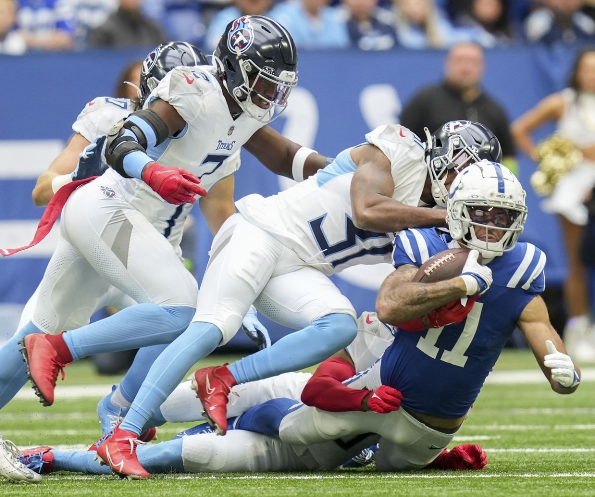 Indianapolis Colts wide receiver Michael Pittman Jr. (11) is brought down while rushing the ball during a game against the Tennessee Titans at Lucas Oil Stadium in Indianapolis.