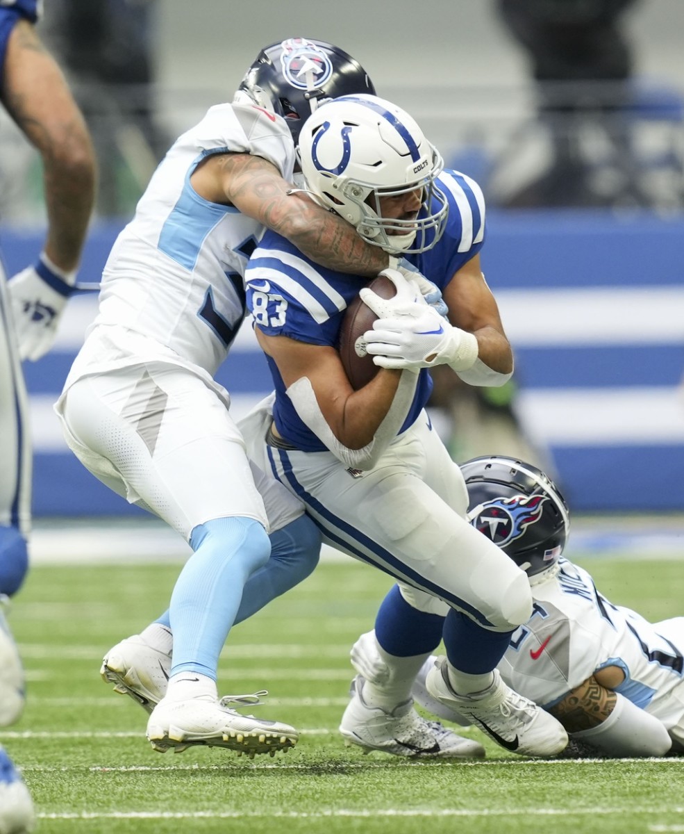 Indianapolis Colts tight end Kylen Granson (83) is brought down by Tennessee Titans defenders during a game at Oil Stadium.