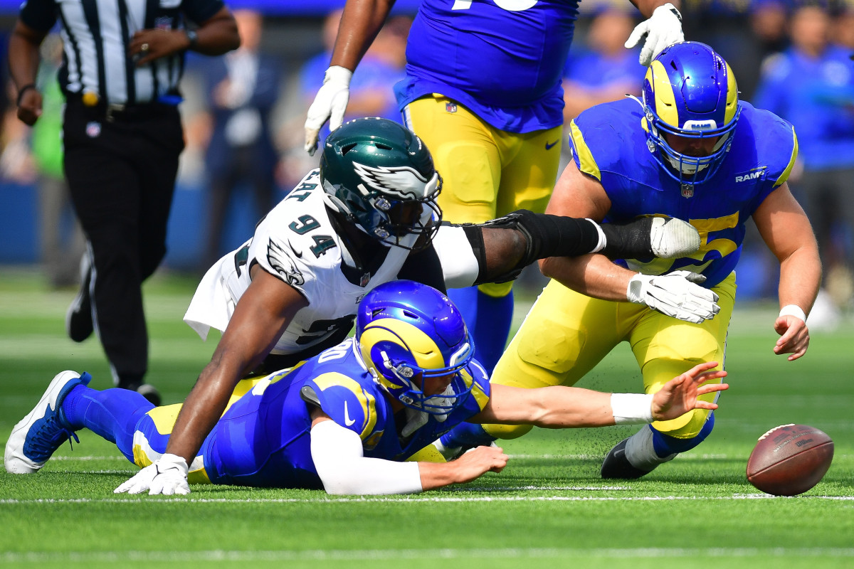 Oct 8, 2023; Inglewood, California, USA; Philadelphia Eagles defensive end Josh Sweat (94) moves in for the ball as Los Angeles Rams guard Coleman Shelton (65) helps quarterback Matthew Stafford (9) recover during the first half at SoFi Stadium. Mandatory Credit: Gary A. Vasquez-USA TODAY Sports