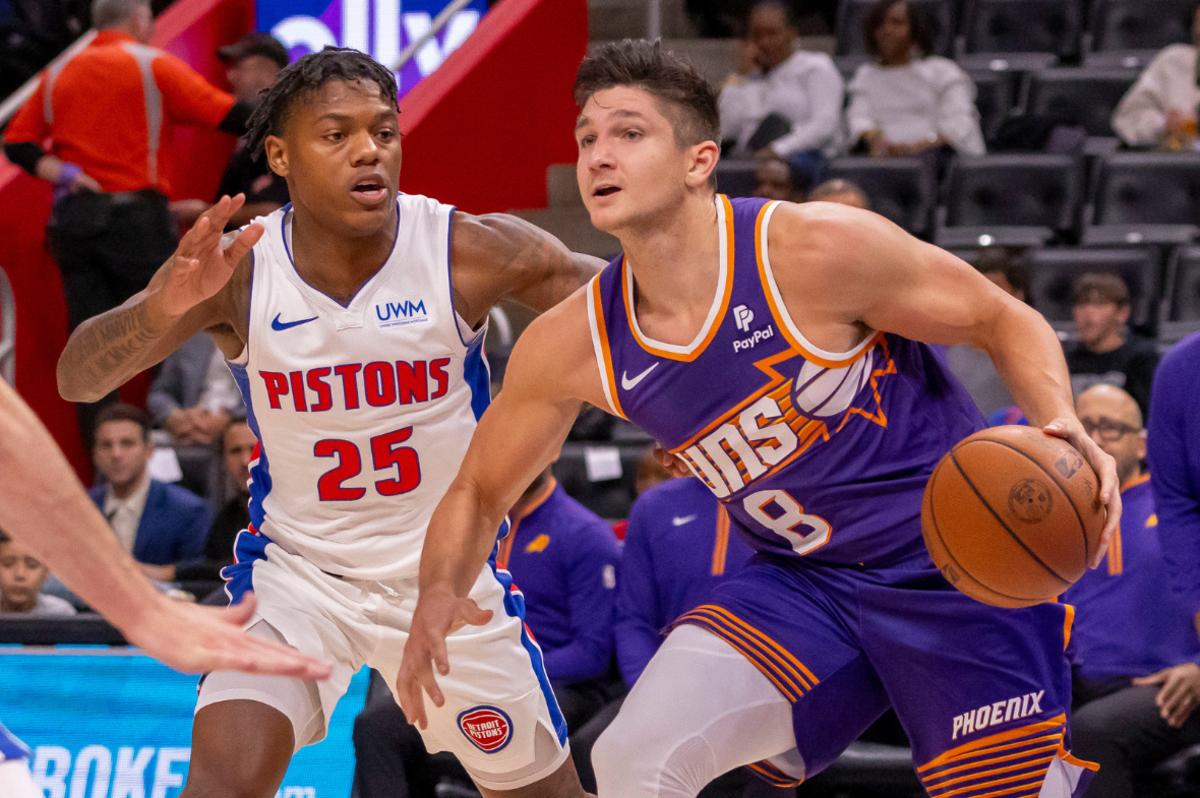 Phoenix Suns guard Grayson Allen (8) controls the ball in front of Detroit Pistons guard Marcus Sasser (25) during the first half of a pre-season game at Little Caesars Arena.