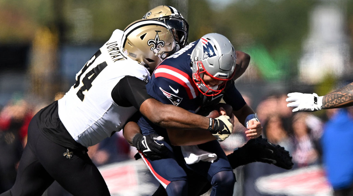 Mac Jones is wrapped up and sacked by the Saints’ Cam Jordan
