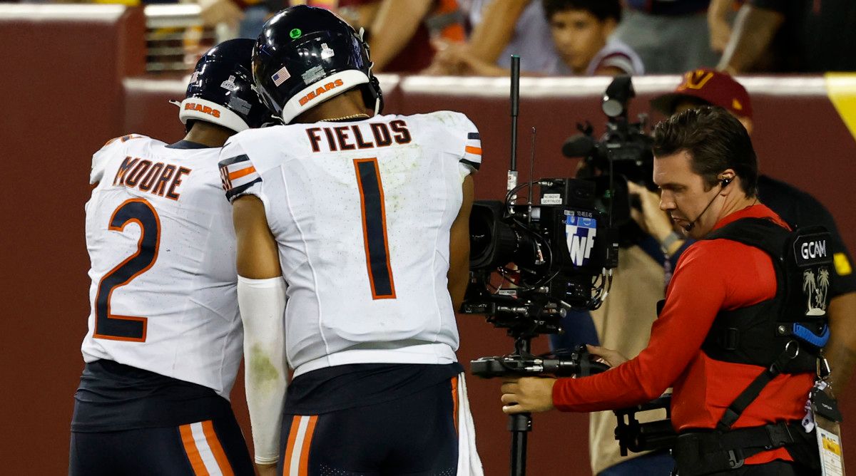 Chicago Bears' WR DJ Moore celebrates with QB Justin Fields during win over the Washington Commanders