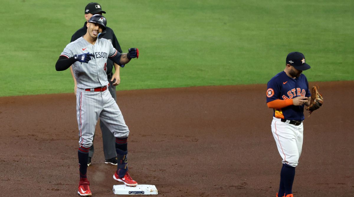 Carlos Correa celebrating a hit against the Astros.