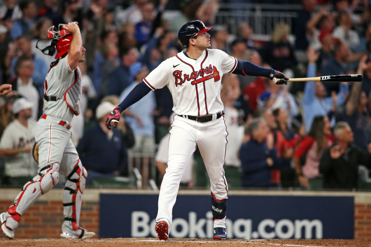 Oct 9, 2023; Cumberland, Georgia, USA; Atlanta Braves third baseman Austin Riley (27) hits a two run home run during the eighth inning against the Philadelphia Phillies in game two of the NLDS for the 2023 MLB playoffs at Truist Park.