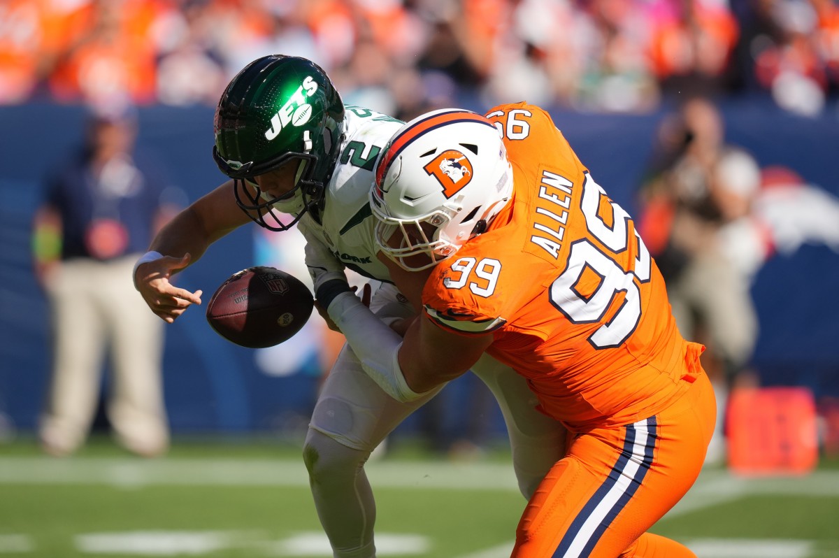 New York Jets quarterback Zach Wilson (2) fumbles after a sack by Denver Broncos defensive end Zach Allen (99) in the first quarter at Empower Field at Mile High.