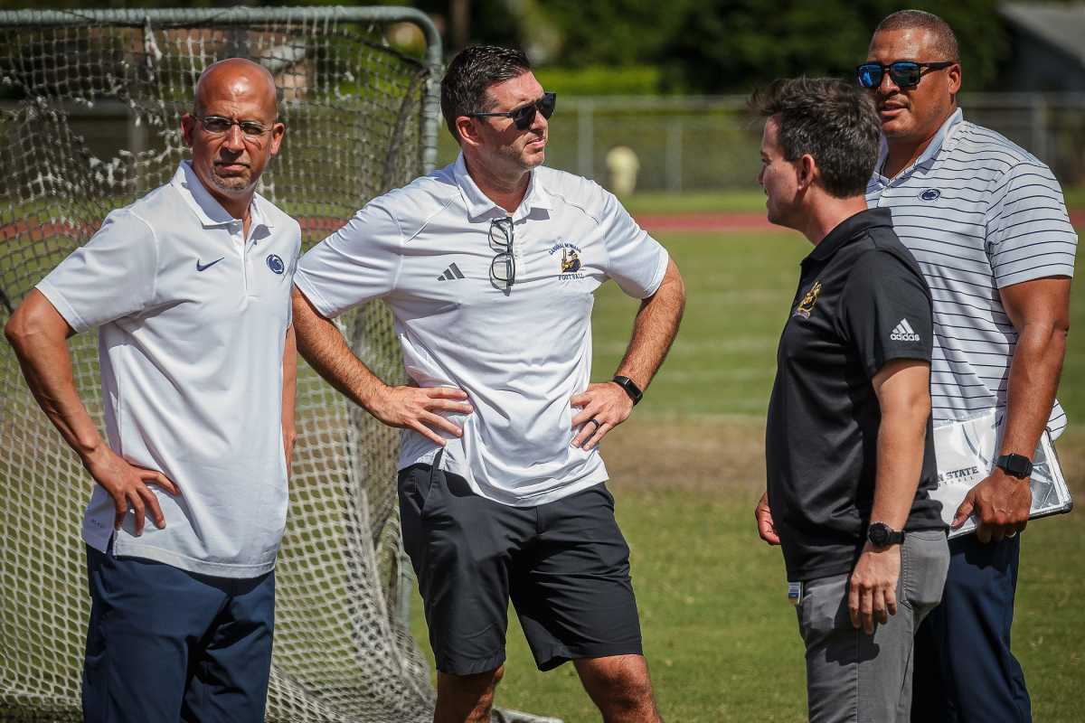 From left to right, Penn State coach James Franklin, Cardinal Newman High School assistant athletic director Ryan Partridge, CNHS athletic director Reilly Campbell and Penn State assistant coach Ja'Juan Seider chat on the school's football field in West Palm Beach, Florida, on Oct. 6.